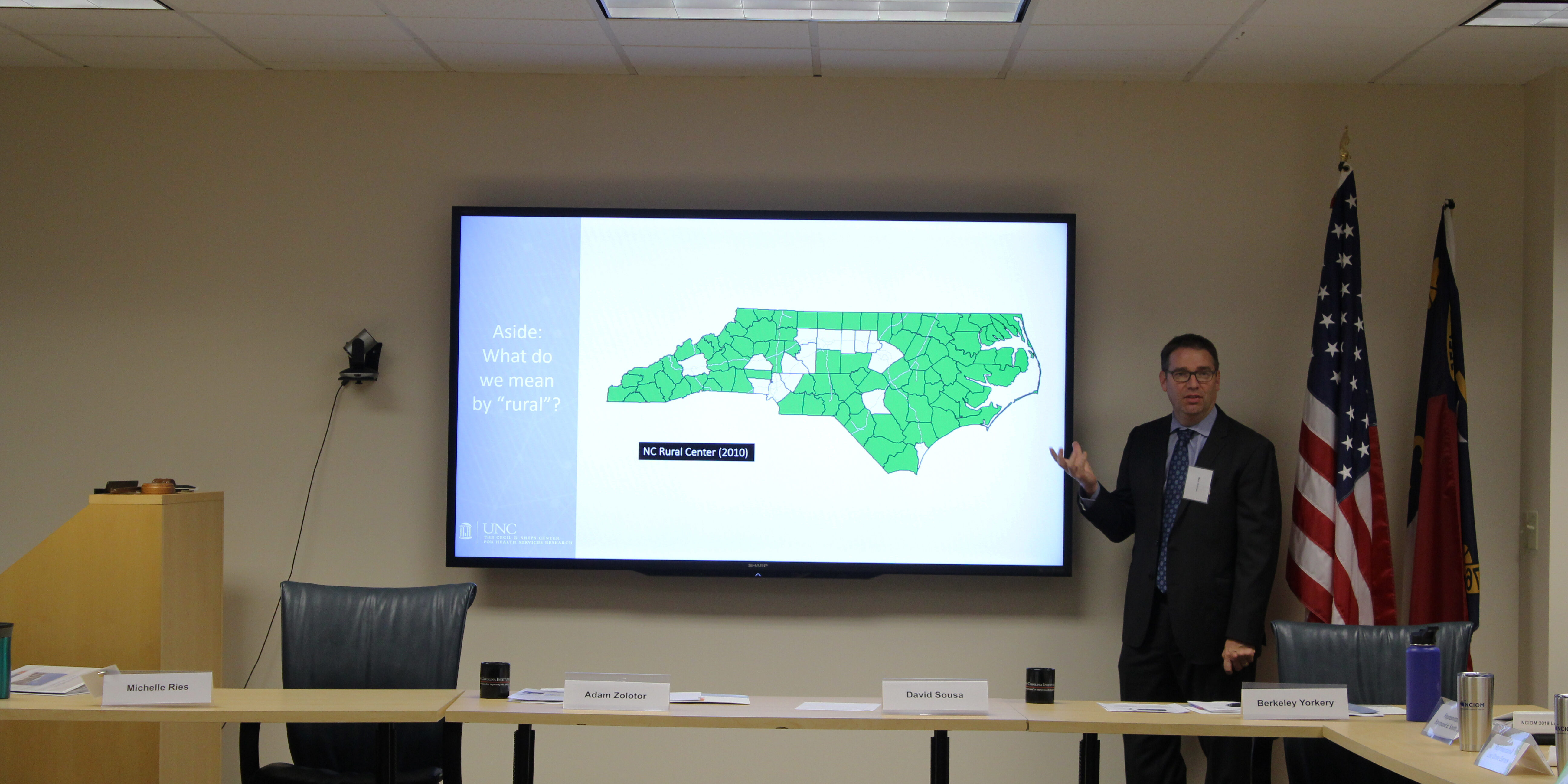 Man gestures at presentation with NC map